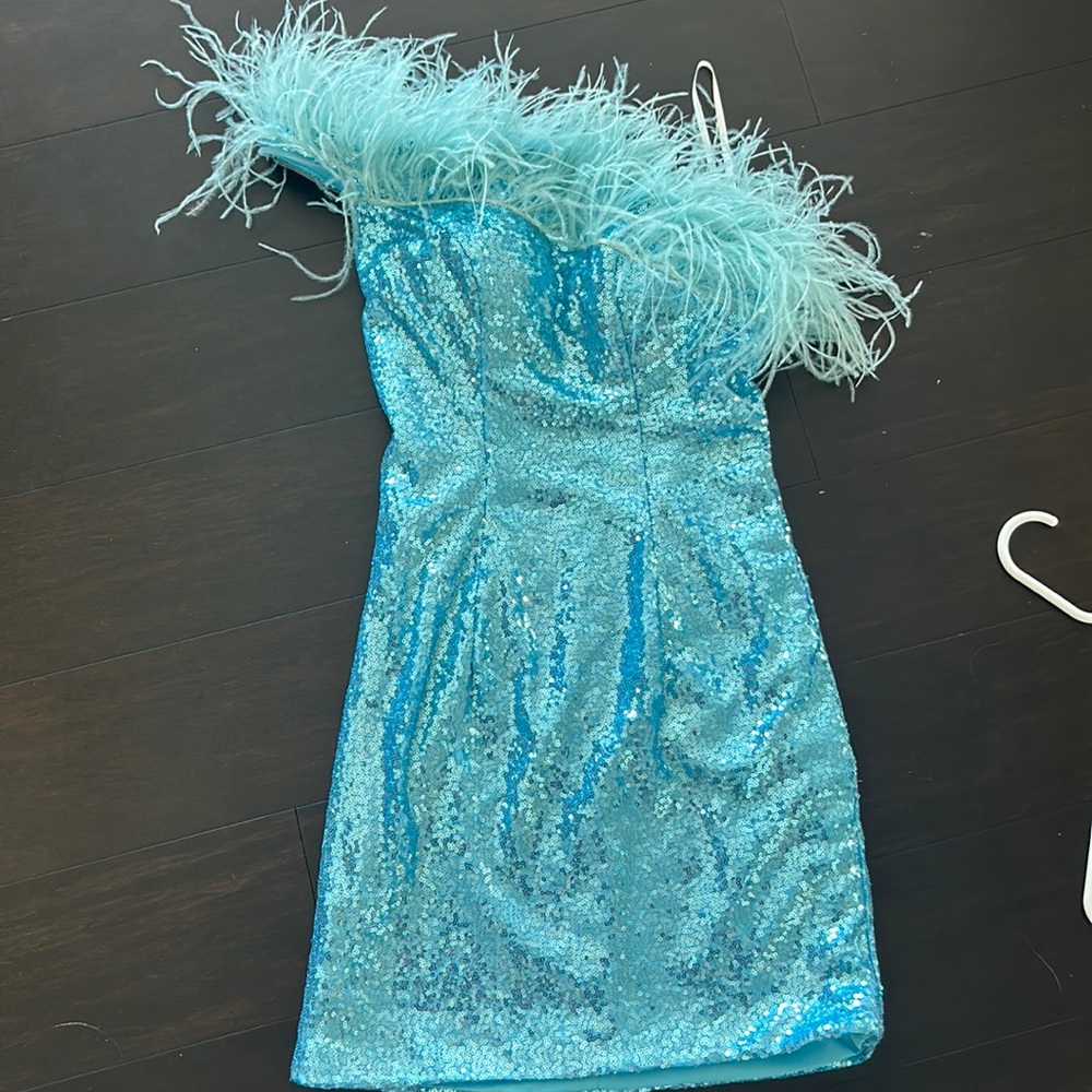 Blue sequin hoco/ cocktail dress. One shoulder and feathers. Has padding in bra